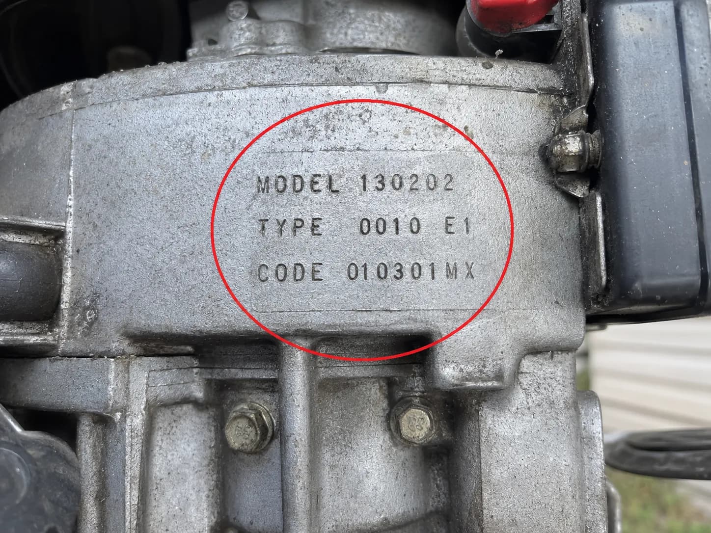 Briggs & Stratton blower housing with the stamped Model, Type, and Code numbers circled to show the engine identification location.