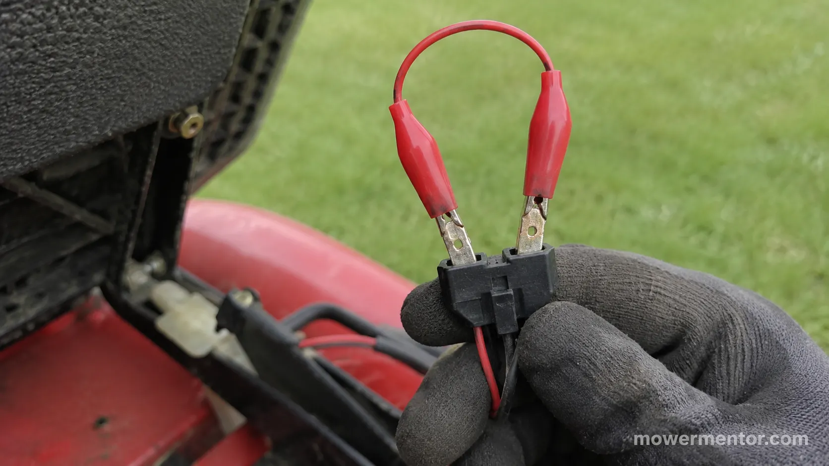Insulated jumper wire bridging a Craftsman seat switch connector for testing
