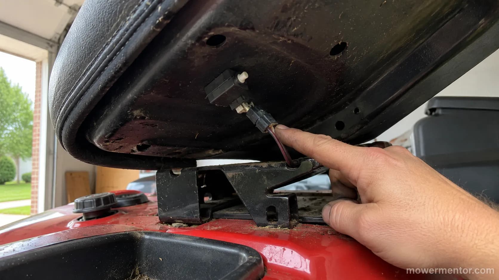 Craftsman seat safety switch clipped under the seat pan with its connector