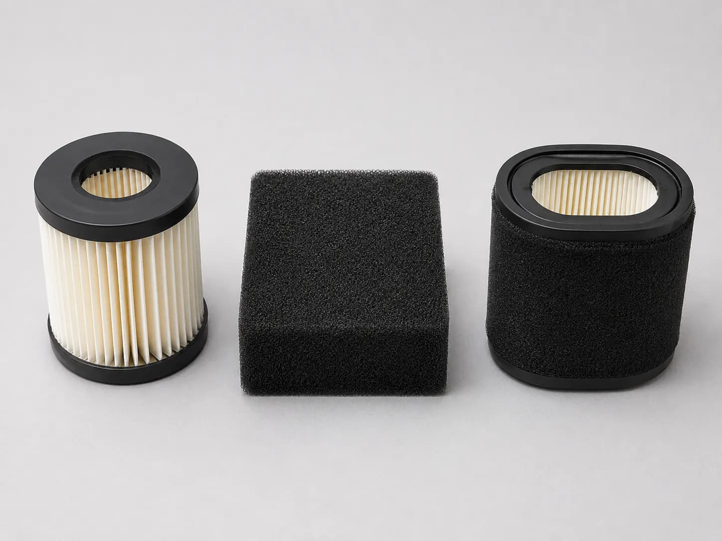 Three common Husqvarna lawn mower air filter types arranged side by side, including a cylindrical paper cartridge, foam filter, and paper cartridge with foam pre-cleaner sleeve.