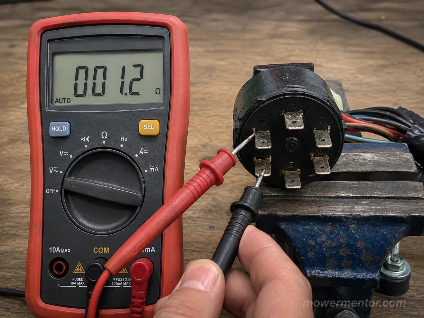 Testing a PTO switch pinout for continuity with a digital multimeter.