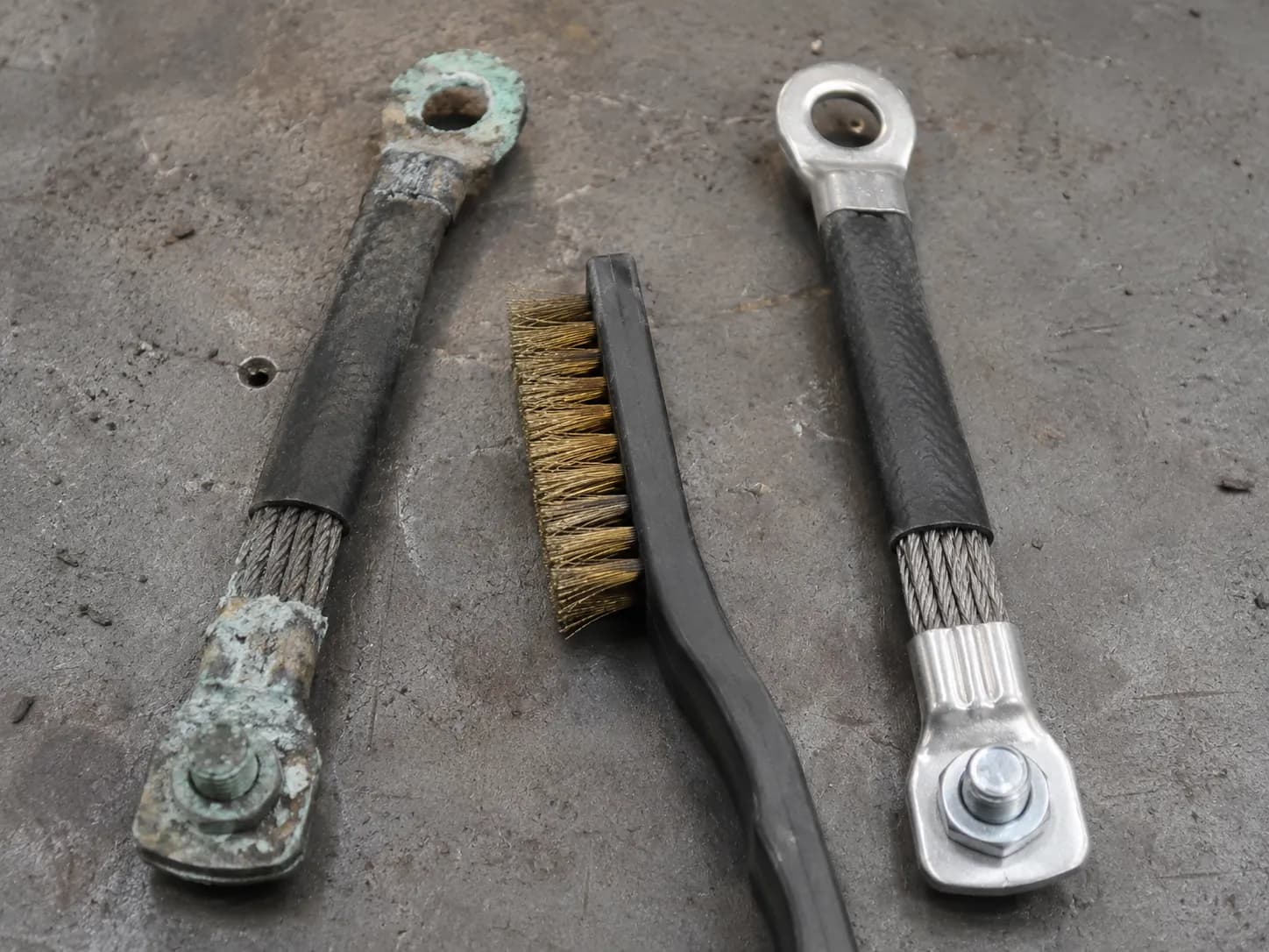 Corroded riding mower ground strap before and after cleaning to bare metal