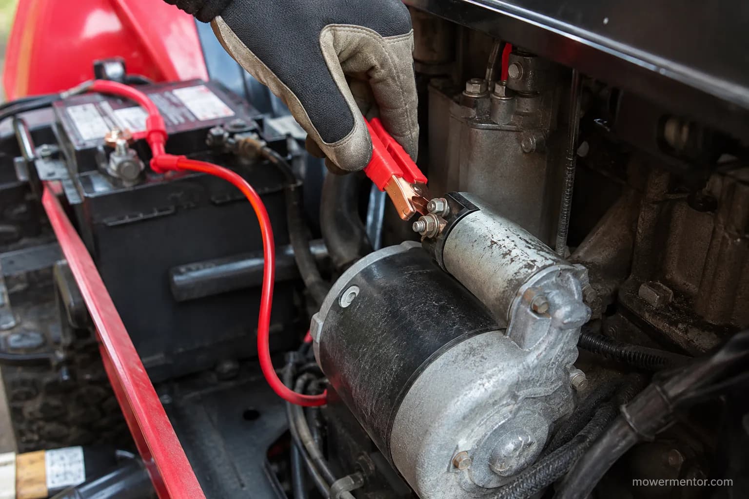 jumper lead feeding battery power directly to a riding mower starter terminal during testing