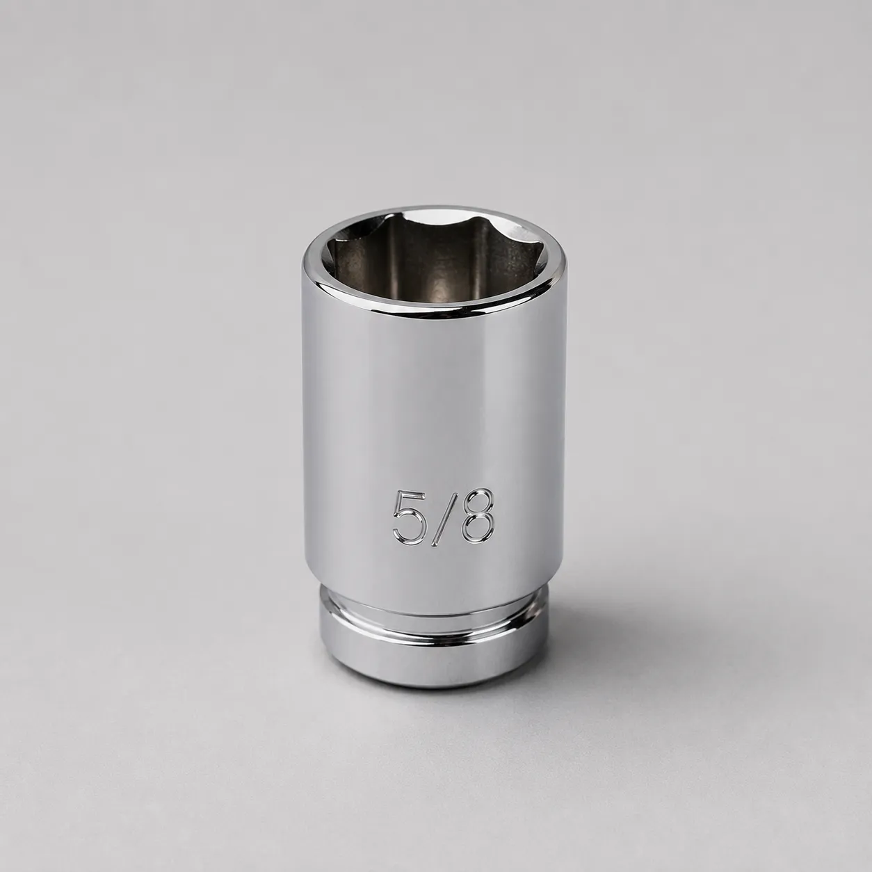 Single 5/8-inch chrome spark plug socket standing upright on a light gray background, showing the standard socket used for most lawn mower and small engine spark plug replacement.