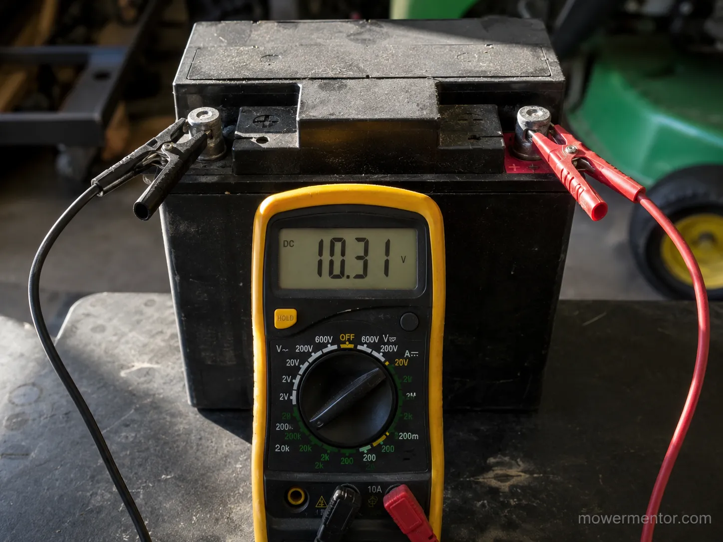 Multimeter showing a riding mower battery that will not hold a charge at 10.3 volts.