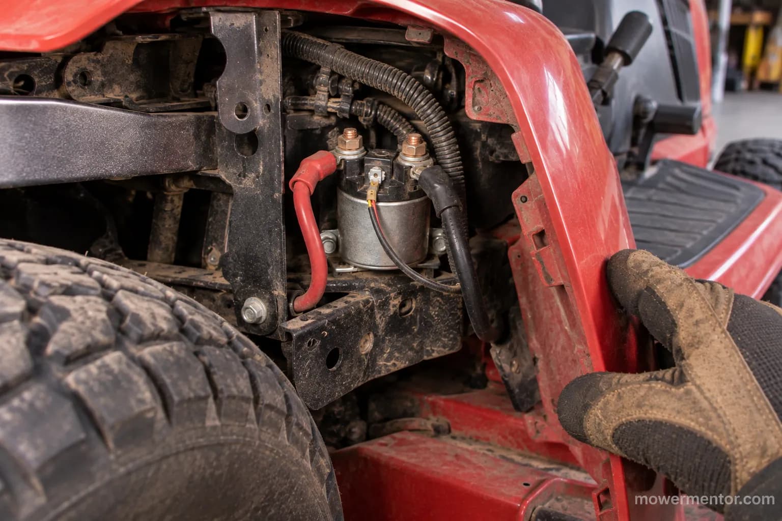 Starter solenoid located behind the right fender panel on a Husqvarna GT-series tractor