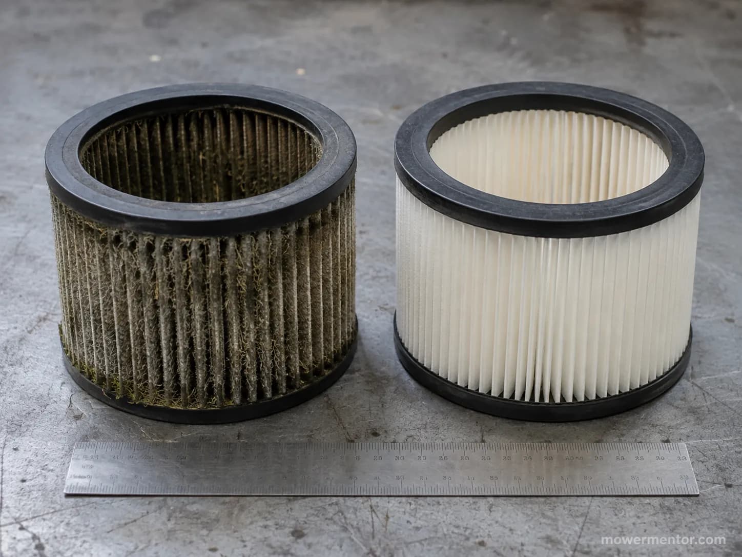 Used lawn mower air filter packed with dust beside a clean replacement filter, showing the difference after two seasons of use.