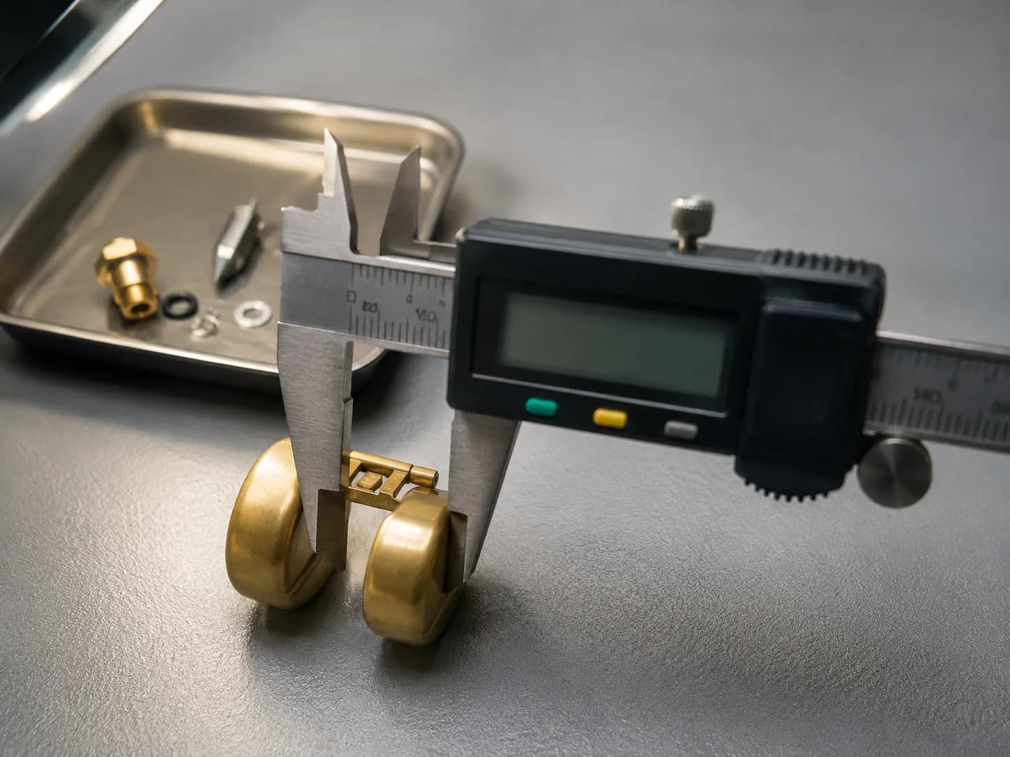 Digital caliper measuring the height of a brass carburetor float on a workshop bench before refitting, with a needle and seat kit in a parts tray behind.