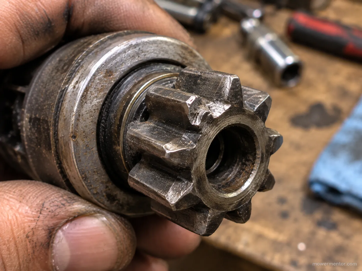 Worn and chipped drive tooth on a used Murray mower starter