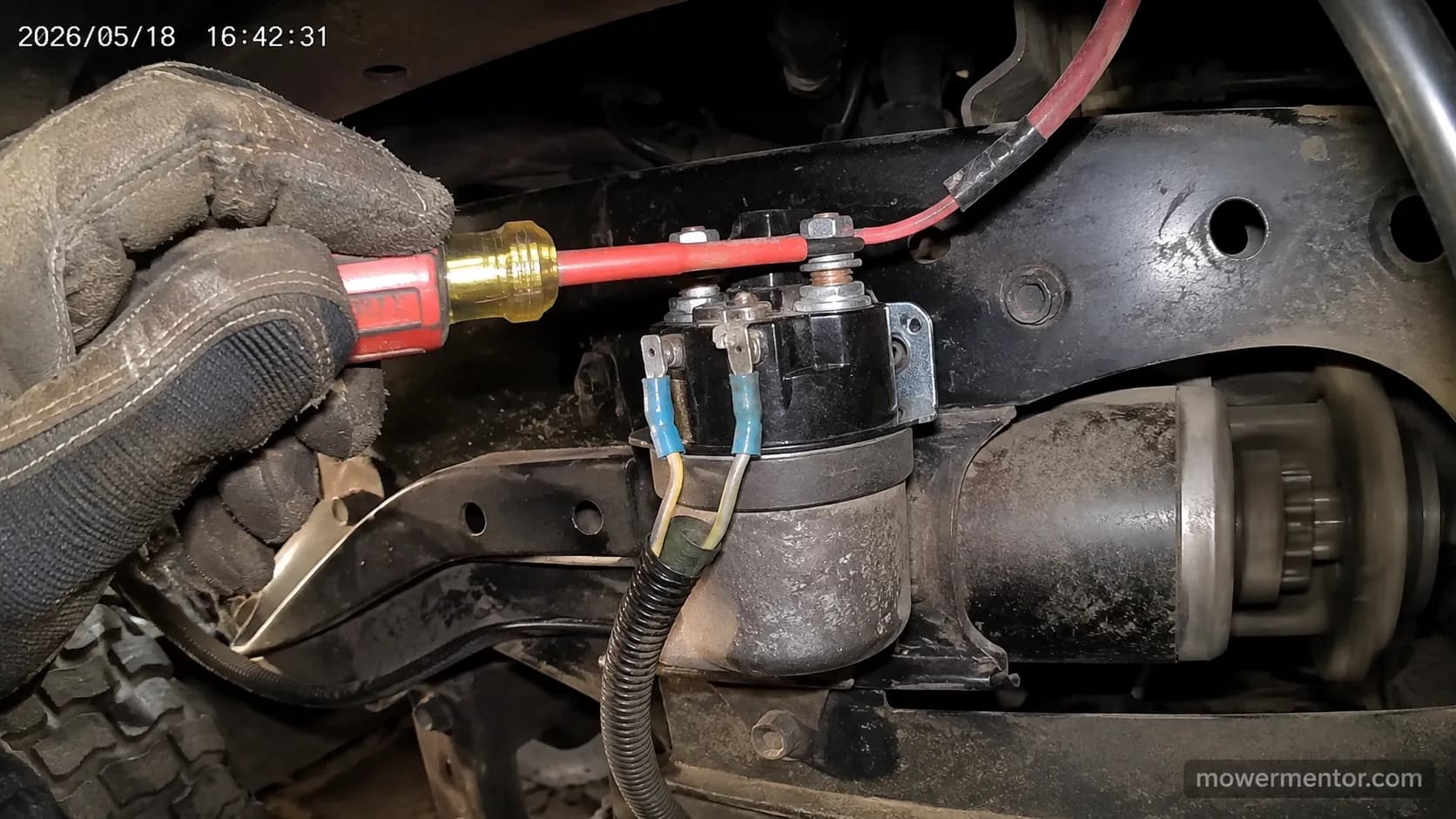 screwdriver test bridging a riding mower starter solenoid while the starter spins