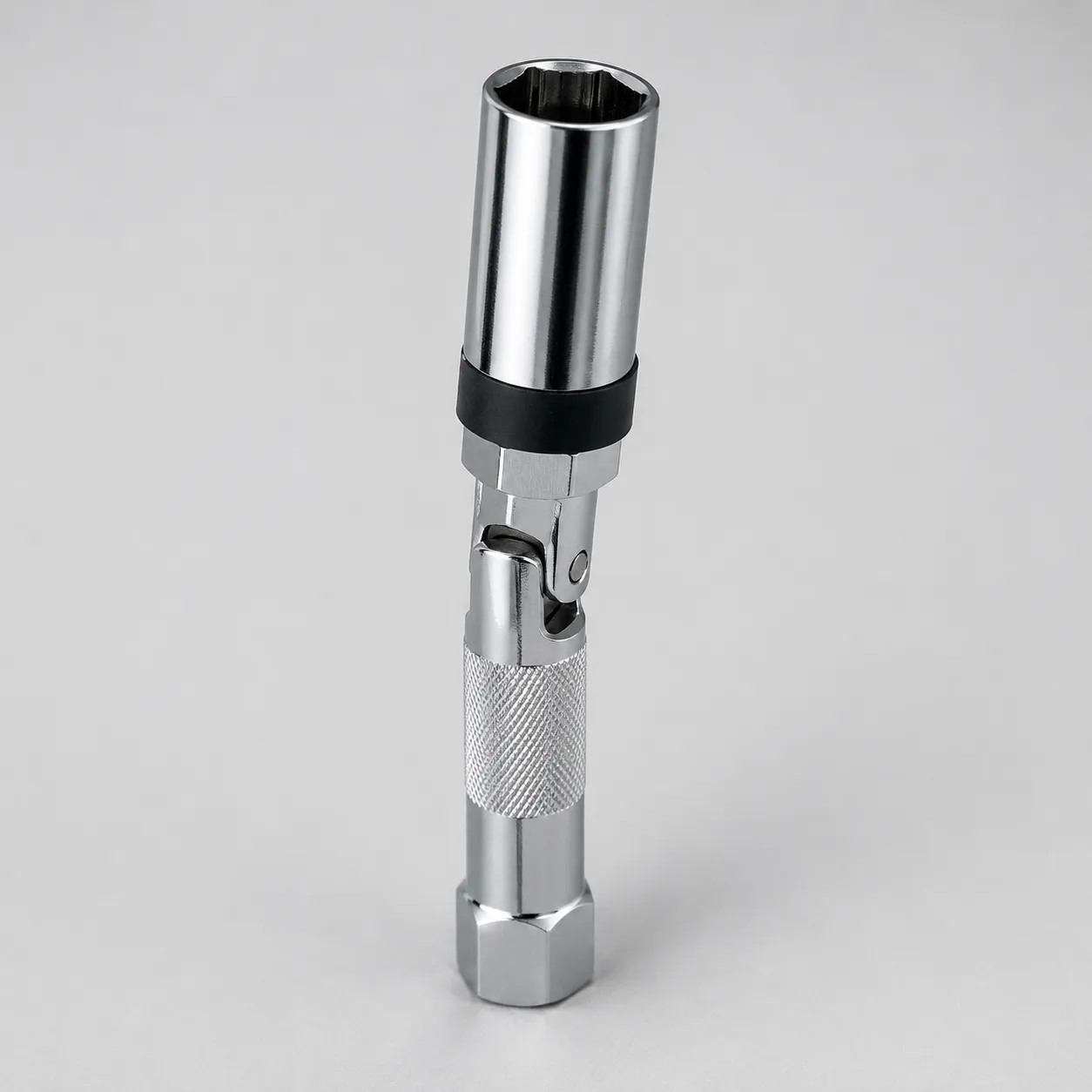 Studio product photo of a swivel spark plug socket with a universal joint, knurled grip, and dual plug-retention design that lifts the spark plug instead of leaving the rubber grommet behind.