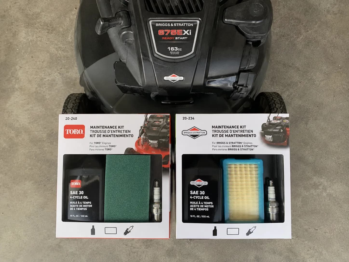 Top-down view of Toro and Briggs & Stratton lawn mower maintenance kits placed side by side beneath an engine label, showing how the engine brand determines the correct service kit.